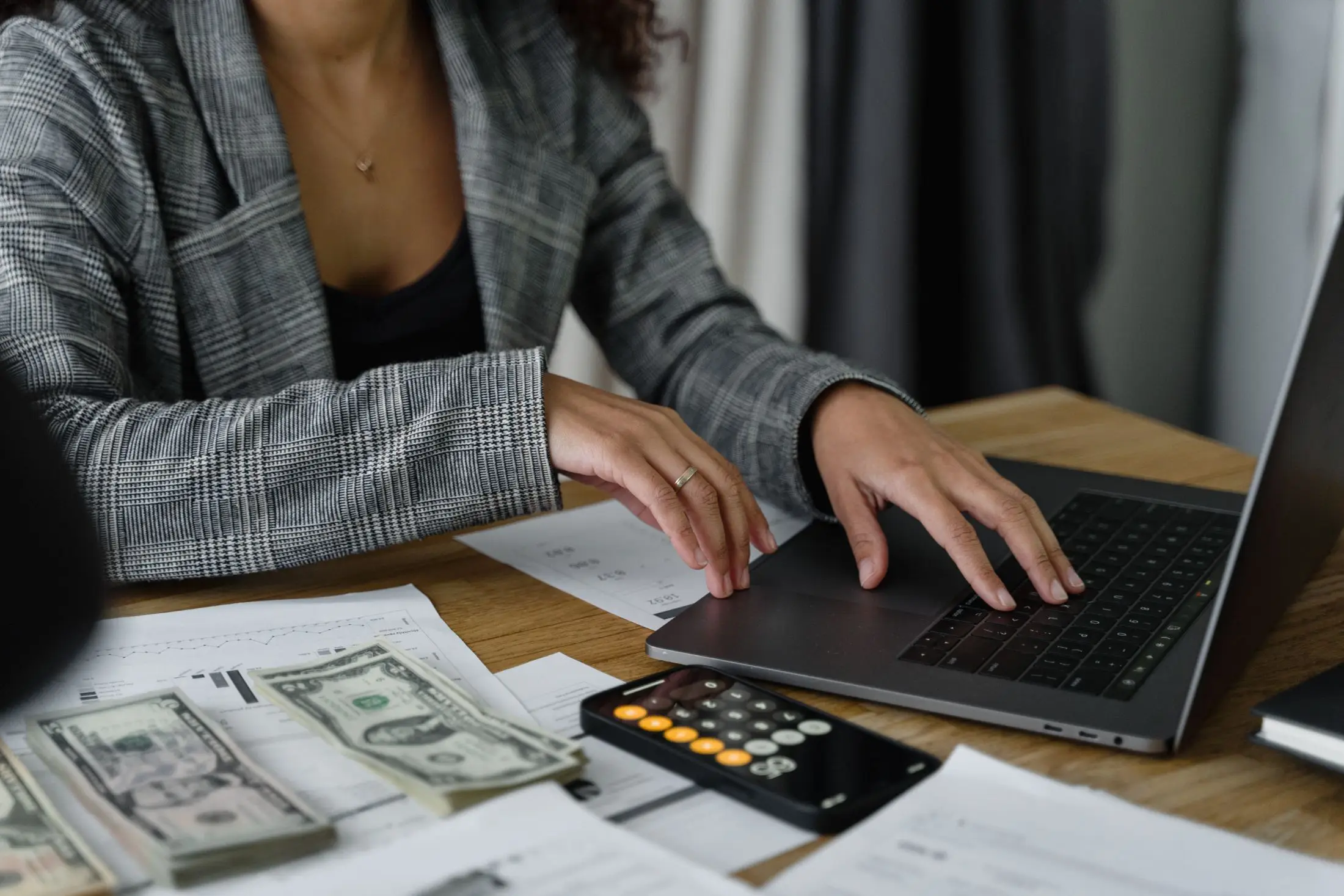 Accounting professional reviewing firm workflow and productivity on a laptop