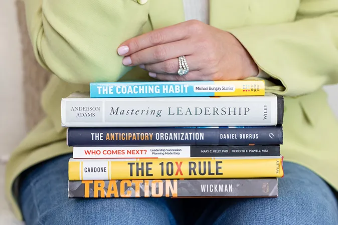 Stack of leadership books recommended by Erin Daiber